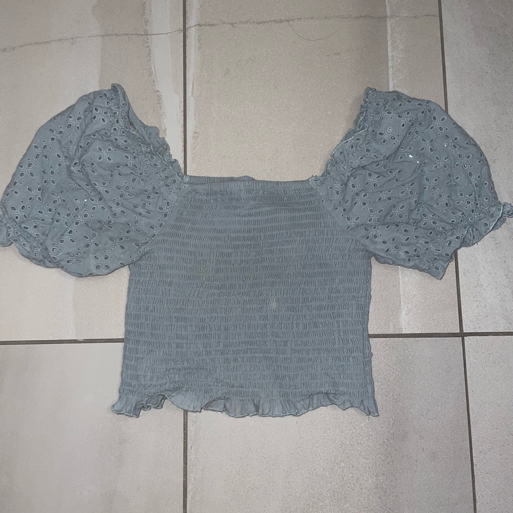 Light blue shirt, cap sleeves, tighter body, pretty dot details